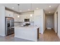 Modern eat-in kitchen with stainless steel appliances, white cabinetry, and large center island at 2824 Supermarine Rd, Tavares, FL 32778