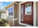 Close up of home's front door showing a decorative door with sidelights at 3139 Hurston Watch Ln, Clermont, FL 34711