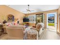 Cozy living room with comfortable seating, neutral colors, and natural light streaming through the windows and door at 3349 Ashbrook Pl, The Villages, FL 32162