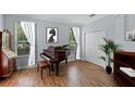 Bright office featuring wood floors, a large window, and a dark wood desk at 3430 Turningwind Ln, Winter Garden, FL 34787