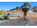 Charming single-story home featuring a well-kept stone landscaped yard and a palm tree at 427 Cambio Ct, The Villages, FL 32159