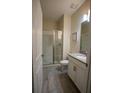 Clean bathroom featuring a glass-enclosed shower, a single sink vanity, and neutral tile floors at 4836 Romeo Cir, Kissimmee, FL 34746