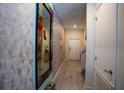 Welcoming tiled entryway with decorative mirror and wall accents, leading into the main living space at 4836 Romeo Cir, Kissimmee, FL 34746