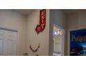 Unique decor on hallway wall with bathroom and decorative bedroom doors nearby at 4836 Romeo Cir, Kissimmee, FL 34746