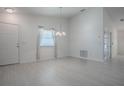 Bright and airy living room with white walls, modern flooring, and a stylish chandelier at 485 Pixie Ln, The Villages, FL 32162