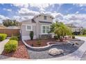 Close-up of the front yard showing meticulous landscaping with rocks and a palm tree at 5551 Purslane Pl, The Villages, FL 32163
