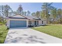 Inviting home showcasing a well-manicured lawn and a quaint entryway, perfect for creating a welcoming atmosphere at 565 Malauka Radl, Ocklawaha, FL 32179