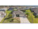 Aerial shot of the property showcasing its expansive lot, well-kept lawn, and appealing exterior at 712 Krietemeyer Path, The Villages, FL 32163