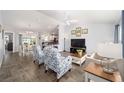 Bright living room featuring an open-concept layout, neutral walls and gray flooring at 781 Nancy Dr, The Villages, FL 32163