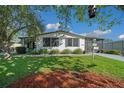 Charming single-story home with well-maintained lawn and landscaping at 915 Oleander St, Lady Lake, FL 32159