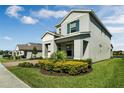 Charming two-story home featuring professionally landscaped front yard and partial view of lake at 9729 Lost Creek Dr, Winter Garden, FL 34787