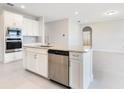 Modern kitchen featuring stainless steel appliances, granite countertops, and white cabinets at 9729 Lost Creek Dr, Winter Garden, FL 34787