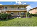 Condominium building with well-maintained lawn and landscaping with stairs leading to the second level units at 1100 E Caroline St # 218, Tavares, FL 32778