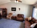 Comfortable living room showcasing couches, recliners, and a built-in bookshelf perfect for lounging at 1108 Ben Hope Dr, Leesburg, FL 34788