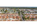 Neighborhood aerial view showcases a well-planned community with neatly arranged homes and greenery at 1202 San Bernardo Rd, The Villages, FL 32162