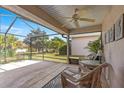 Enjoy outdoor living on this screened-in patio with a ceiling fan and comfortable wicker furniture at 12225 Se 173Rd Pl, Summerfield,, FL 34491