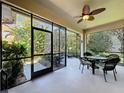 Screened lanai featuring an outdoor ceiling fan and patio furniture, with a view of the backyard at 12919 Freeman St, Windermere, FL 34786