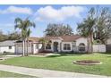 Charming single-story home with lush lawn, complemented by elegant landscaping and a welcoming entrance at 15912 Lake Orienta Ct, Clermont, FL 34711