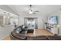 Bright living room with sliding glass doors to the backyard and stylish furnishings at 15912 Lake Orienta Ct, Clermont, FL 34711