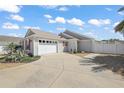 A beautiful home featuring a spacious driveway leading to a two-car garage and lush front yard landscaping at 1781 Kingfisher Ct, The Villages, FL 32162