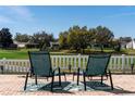 Inviting back patio with comfortable seating overlooking the lush green golf course at 1802 Dalton Dr, The Villages, FL 32162