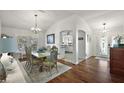 Bright dining room featuring hardwood floors and an open view into kitchen at 2114 Gerardo Ave, The Villages, FL 32159