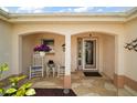 Inviting front porch with decorative chairs and a stylish front door at 2114 Gerardo Ave, The Villages, FL 32159