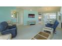 Spacious living room showcasing an entertainment center and views into the dining area at 26315 Newcombe Cir, Leesburg, FL 34748