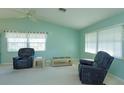 Relaxing living room filled with natural light with neutral carpet and two comfortable armchairs at 26315 Newcombe Cir, Leesburg, FL 34748