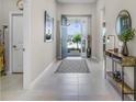 Bright foyer featuring tile flooring, stylish decor, and a welcoming open doorway at 3009 High Pointe St, Clermont, FL 34711