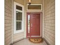 Welcoming front entry with sidelight, transom window, and a stylish 'M' doormat at 3047 Bevill Ln, The Villages, FL 32163