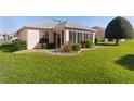 Backyard with a screened-in porch and lush green lawn for outdoor enjoyment at 3056 Saint Thomas Ln, The Villages, FL 32162