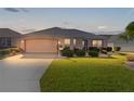 Inviting single-story home boasting a well-maintained lawn and attached two-car garage at 3056 Saint Thomas Ln, The Villages, FL 32162