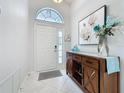 Bright foyer with tile flooring, high ceilings, and elegant decor at 3720 Eversholt St, Clermont, FL 34711