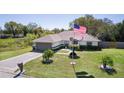 Well-maintained front yard with mature palm trees and American flag at 377 Ed Douglas Rd, Groveland, FL 34736