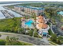 Aerial view of community pool, jacuzzi, pool house and boat slips at 4620 Riverwalk Village Ct # 7505, Ponce Inlet, FL 32127