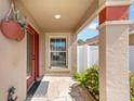 Inviting front entryway with stone flooring, large column, lush landscaping, and decor at 483 Cammarano Pl, The Villages, FL 32162