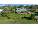 A picturesque view of the home showcasing mature landscaping, and beautiful lawn at 4940 County Road 134B, Wildwood, FL 34785