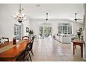 Bright and open-concept living area featuring tiled floors and sliding glass doors to the pool at 6035 Falconbridge Pl, Mount Dora, FL 32757
