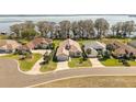 A beautiful aerial view of a lakeside residential neighborhood, showcasing well-maintained homes and lush greenery at 6342 Sailboat Ave, Tavares, FL 32778