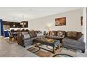 Comfortable living room showcasing tile floors, plush seating, and an inviting atmosphere at 9040 Azalea Sands Ln, Davenport, FL 33896