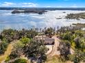 Breathtaking aerial view of an estate with lake access and lush landscaping at 10944 Autumn Ln, Clermont, FL 34711