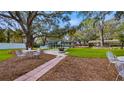 Lush backyard featuring a patio, fire pit, and seating area, perfect for entertaining at 11136 Bronson Rd, Clermont, FL 34711