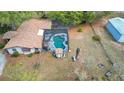 Aerial view of a pool, the back of the house, and the fenced backyard at 1236 Selman Rd, Leesburg, FL 34748