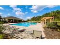 Enjoy the sunshine and the beautiful view by the community pool at 125 Sunny Day Way, Davenport, FL 33897