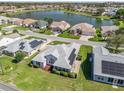 Gorgeous aerial view of home with solar panels overlooking a serene lake in a neighborhood at 1256 Camero Dr, The Villages, FL 32159