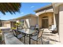 Inviting front porch with patio furniture and a beautifully landscaped yard, perfect for relaxing outdoors at 1357 Owl Dr, The Villages, FL 32163