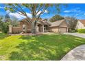 Beautifully landscaped single-Gathering home with well-maintained lawn at 17408 Tailfeather Ct, Clermont, FL 34711