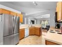 Open kitchen with stainless steel refrigerator and view to the living room area at 1917 Emily Blvd, Winter Haven, FL 33884