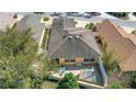 Aerial view showcasing the home's backyard with patio, seating and private hot tub area at 2165 Smoaks St, The Villages, FL 32162